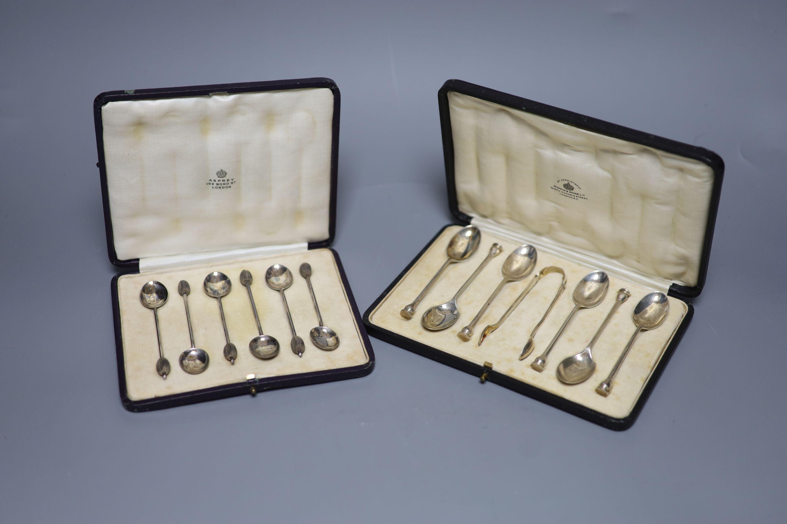 A cased set of six seal top teaspoons and tongs and a cased set of silver silver bean end coffee spoons.